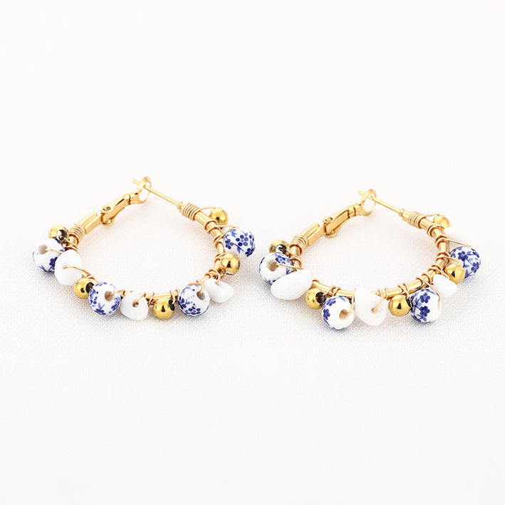 Oorbellen Bedel Strand goud blauw wit liggend