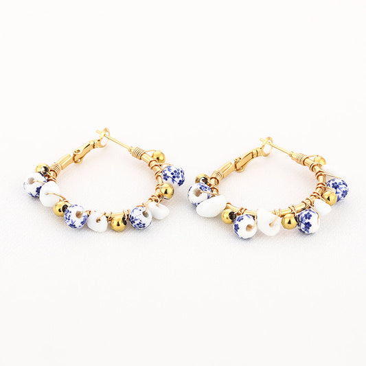 Oorbellen Bedel Strand goud blauw wit liggend
